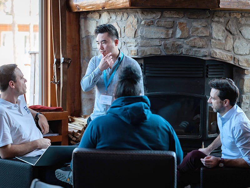 Multi-ethnic-group-of-workers-looking-working-together-sitting-office-interior