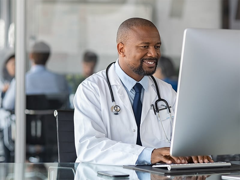 African-mature-doctor-working-on-computer