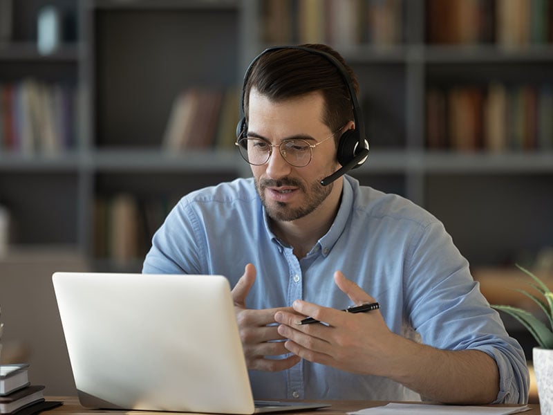 Confident-man-t-wearing-headset-speaking