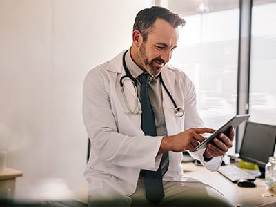 Doctor-using-digital-tablet-at-his-clinic