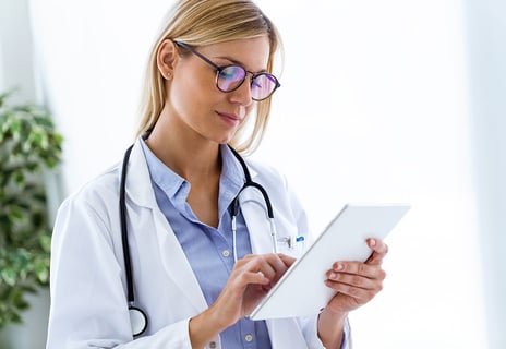 Female-doctor-working-with-laptop-and-researching-some-medication-information-in-the-consultation-1