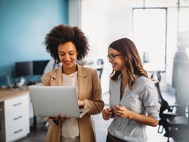 Happy-multiethnic-smiling-business-women-working-together-in-office