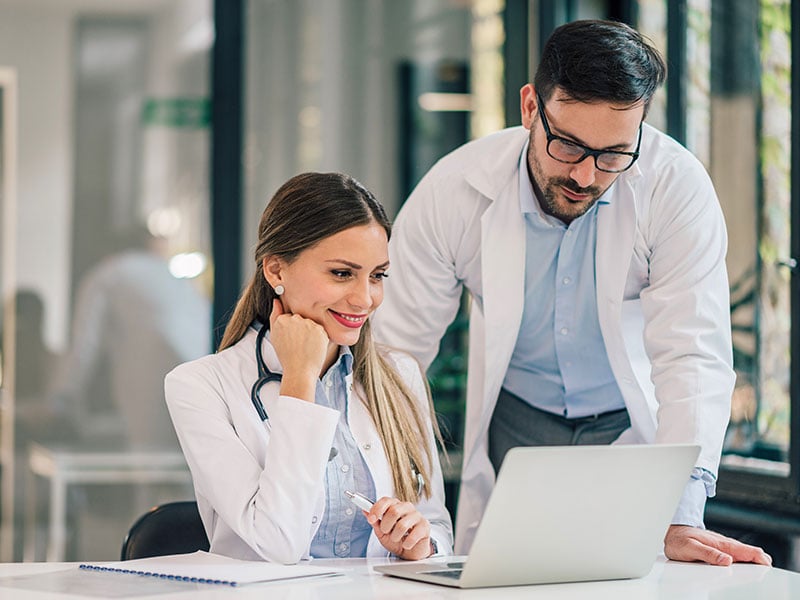 Two-young-doctors-working-together-in-the-office