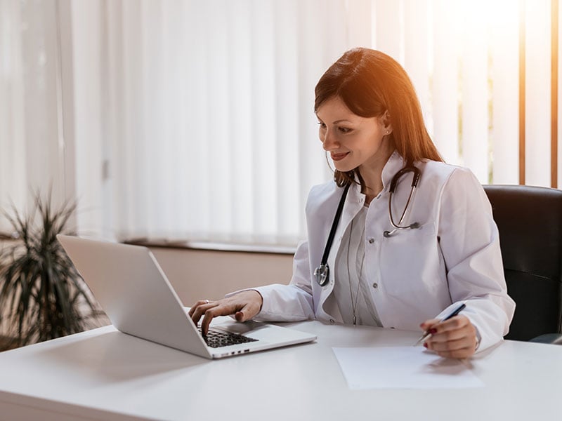 female-doctor-working-on-her-laptop-in-her-office