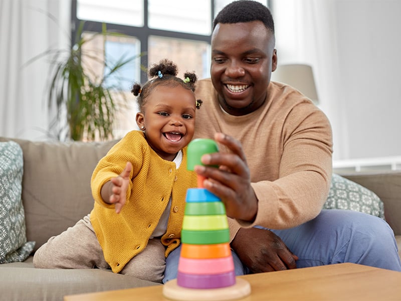 happy-african-american-father-and-baby-daughter-playing-with-toy-blocks-at-home
