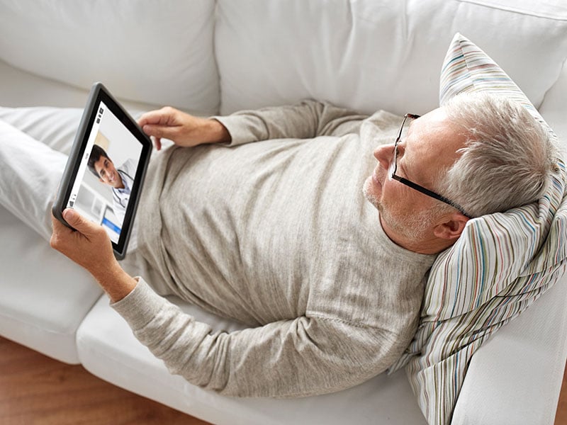 senior-patient-having-video-chat-with-doctor-on-tablet-pc-computer-at-home