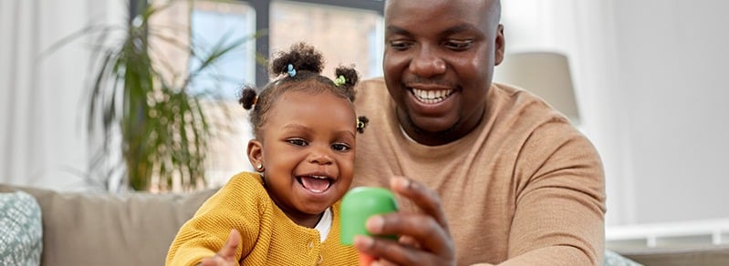 happy-african-american-father-and-baby-daughter-playing-with-toy-blocks-at-home